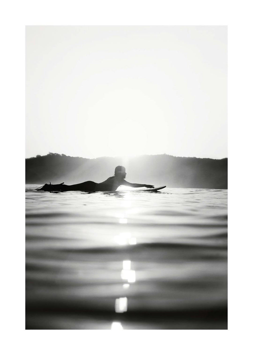 Affiche noir et blanc dun surfeur sur sa planche, le soleil en arrière-plan et son reflet sur leau