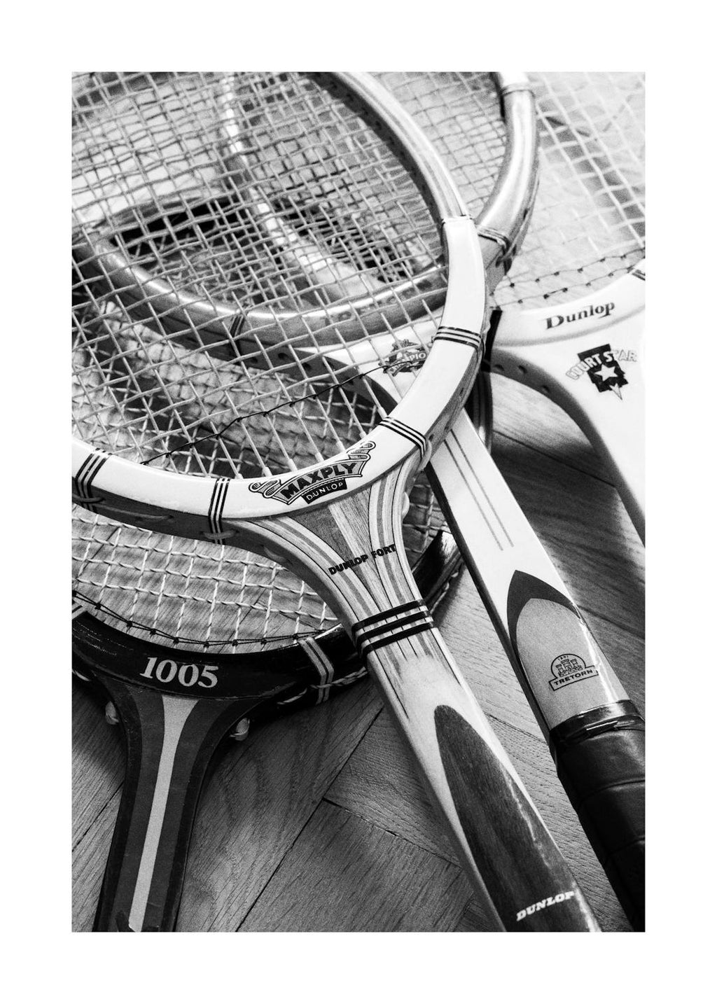 Affiche noir et blanc de raquettes de tennis vintage, style typographie, pour une ambiance sportive classique.
