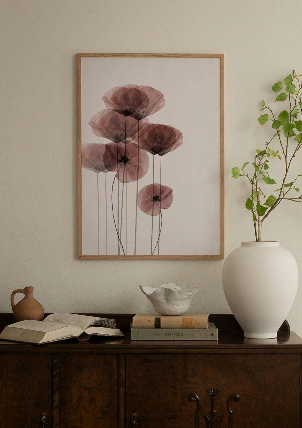 Affiche abstraite de formes organiques beige, rose, jaune et noires, accrochée au mur dun salon moderne.