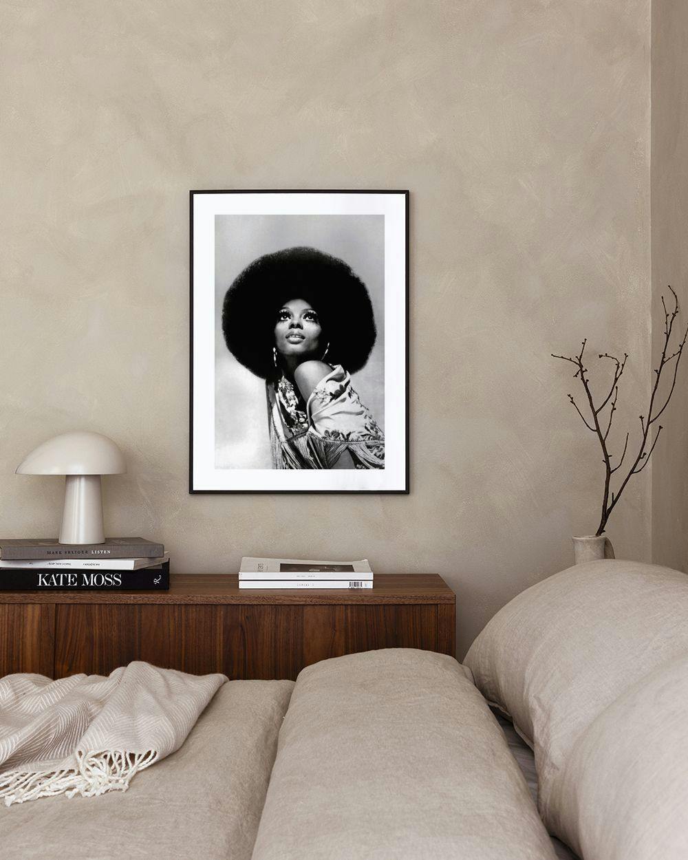 Affiche noir et blanc d’une femme avec une coiffure afro, accrochée dans un salon moderne.